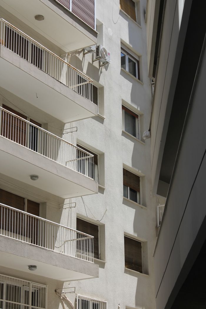 services-02 Close-up view of a modern residential building showcasing balconies and windows.