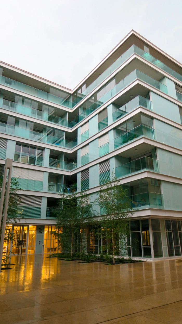 services-01 Contemporary residential building featuring glass balconies against an urban backdrop.